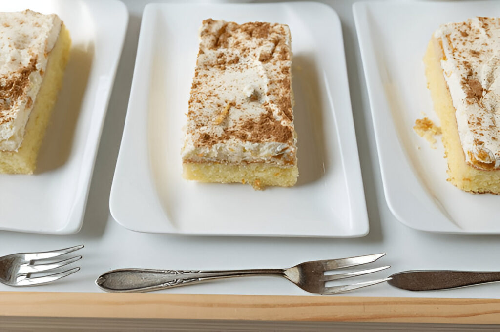 A simple frosted kefir sheet cake, topped with a smooth layer of white frosting and sliced into squares.