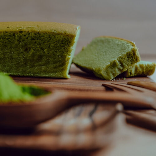 Matcha cake from a side angle, showcasing its vibrant green color and soft texture, a perfect example of Asian desserts.