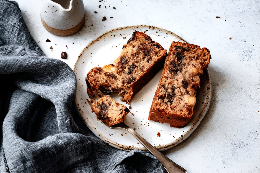 A close-up of 3 Ingredient Banana Bread with chocolate chips, served on a plate.