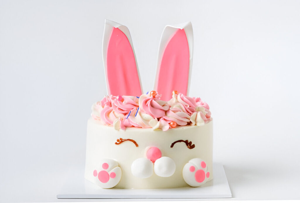 Bunny-shaped gender reveal cake with pink details.