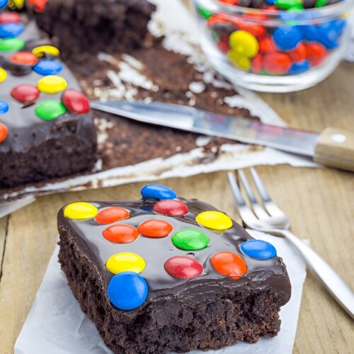 A chewy slice of cosmic brownies with vibrant sprinkles, highlighting its moist and fudgy texture.