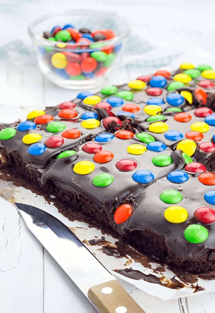 A whole tray of cosmic brownies, topped with chocolate frosting and colorful sprinkles.