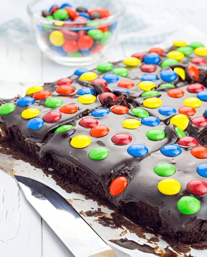 A whole tray of cosmic brownies, topped with chocolate frosting and colorful sprinkles.