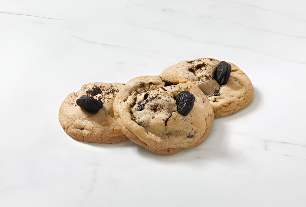 Plate of freshly baked cookies and cream cookies with chunks of Oreos.