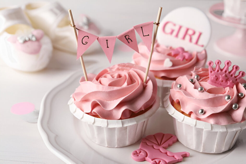 A gender reveal cupcake with pink swirled frosting and a surprise-filled center.