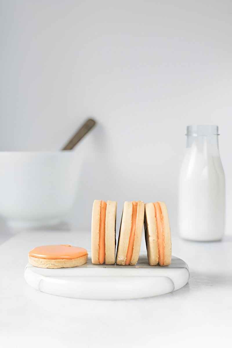 Wafer cookies lined up side by side on a white surface, showing their thin, uniform layers.