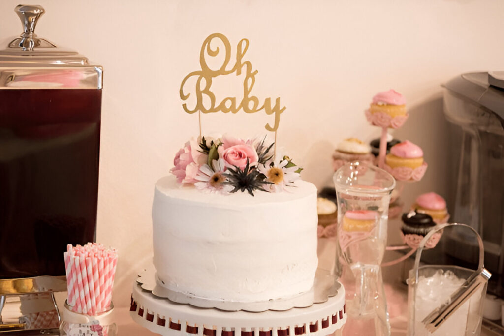 Colorful gender reveal cake with white frosting.